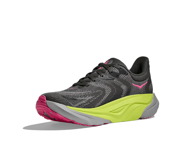 Black, neon green, neon pink, and grey running shoe on a white background
