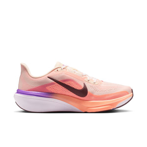 Pink running shoe with a purple sole on a white background