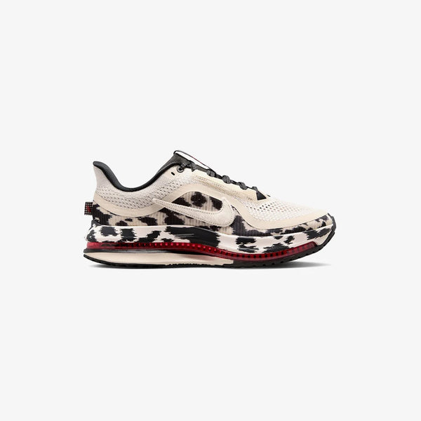 Cow print and red running shoe on a white background