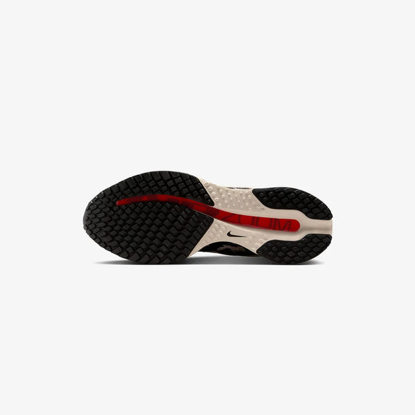 Cow print and red running shoe on a white background