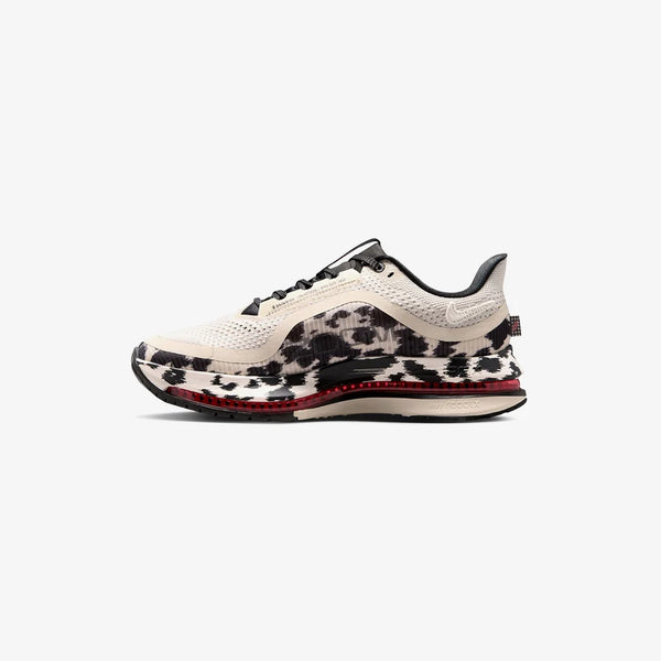 Cow print and red running shoe on a white background