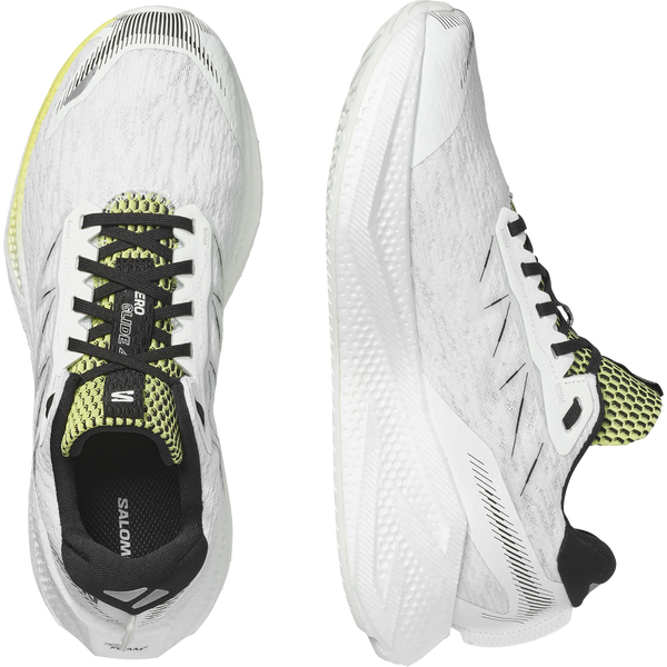 White, lime green, and black running shoe on a white background