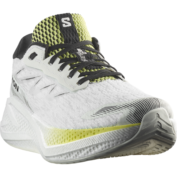 White, lime green, and black running shoe on a white background