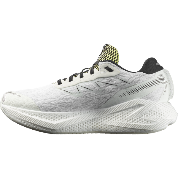 White, lime green, and black running shoe on a white background
