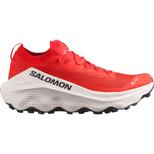 White, red, and black trail running shoe on a white background