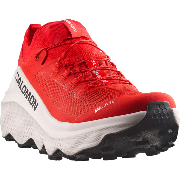 White, red, and black trail running shoe on a white background