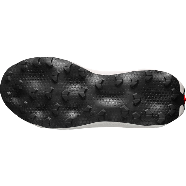 White, red, and black trail running shoe on a white background