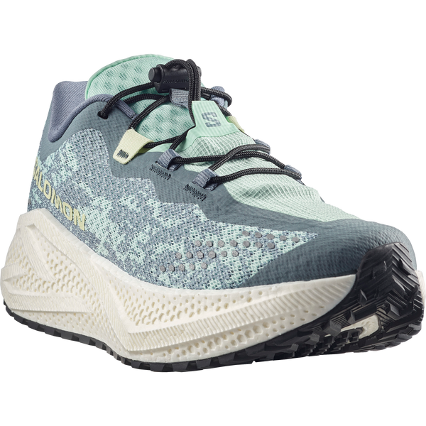 Teal and off-white gravel running shoe on a white background