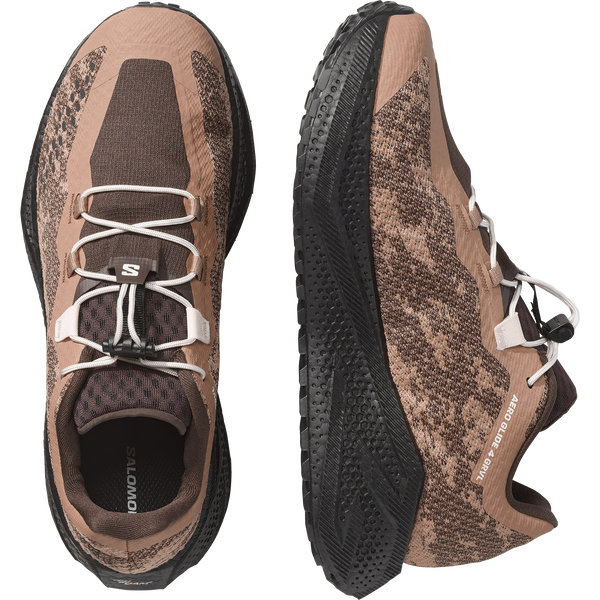 Brown and black gravel running shoe on a white background