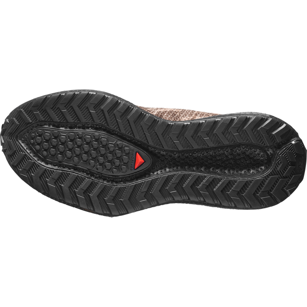 Brown and black gravel running shoe on a white background