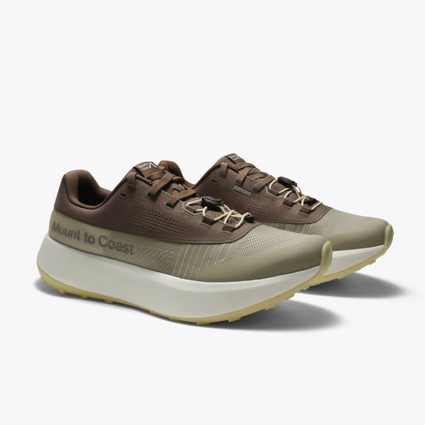 Mount to Coast featuring a brown and olive green upper, a thick cream-colored platform midsole, and a light tan outsole.