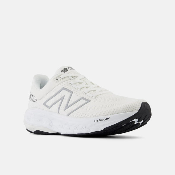 White runew balance running shoe with black sole on a white background