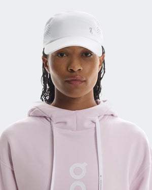 Women wearing a white lightweight cap from the Brand On that is great for running.