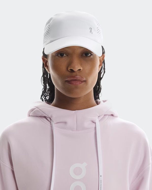 Women wearing a white lightweight cap from the Brand On that is great for running.