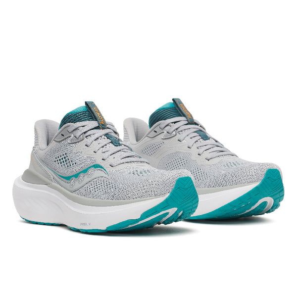 A light gray Saucony running shoe with a thick white midsole and teal accents on the logo, collar lining, and outsole, shown on a white background.