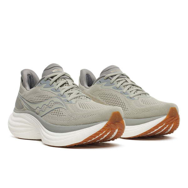 Pair of gray running shoes with white soles on a white background