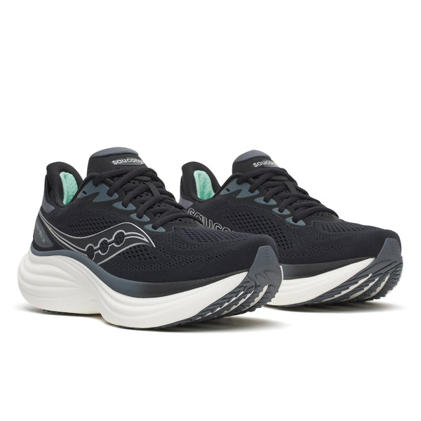 Black running shoes with white soles on a white background