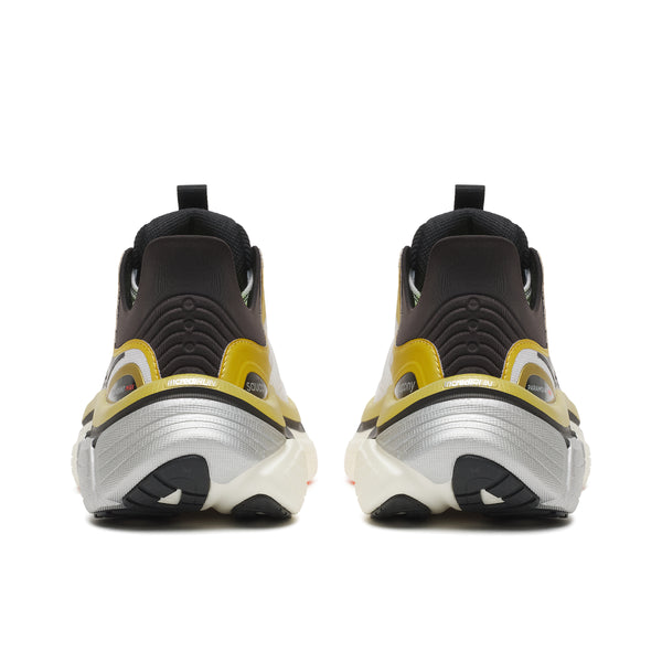 Black and yellow athletic shoes on a white background