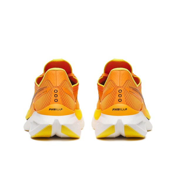 Orange running shoes with white soles on a white background