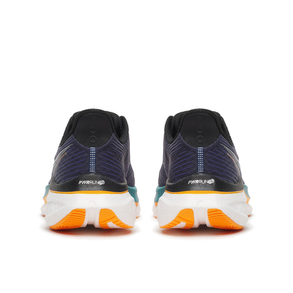 Pair of running shoes with orange soles on a white background