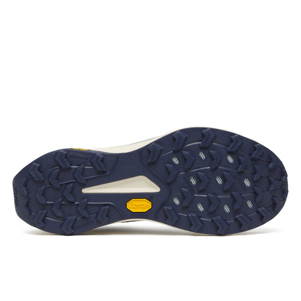 Navy blue outsole of a shoe with a yellow label on a white background