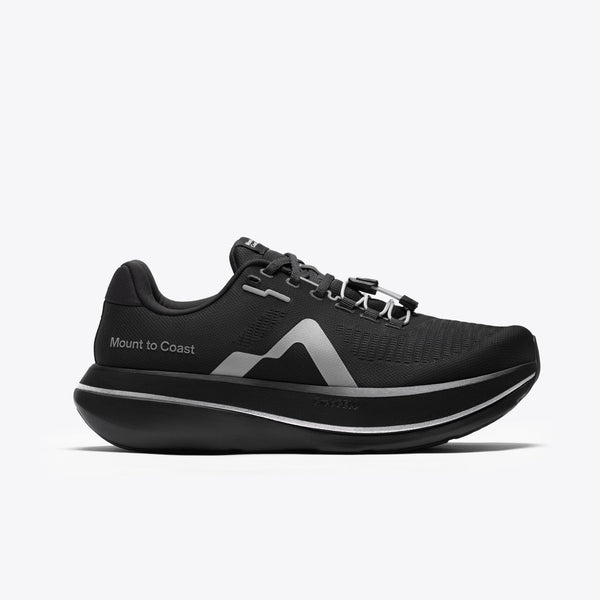 A black Mount to Coast running shoe with a thick black and silver platform sole.