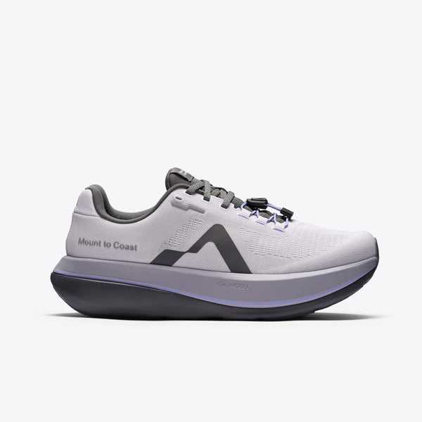 A light gray and purple running shoe with a dark gray sole and logo, featuring the text 'Mount to Coast' on the side