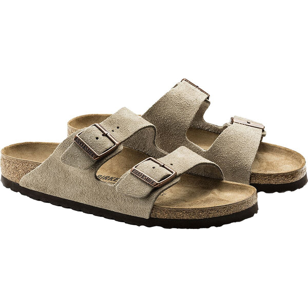 Pair of beige sandals with cork soles on a white background