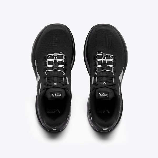 A black Mount to Coast running shoe with a thick black and silver platform sole.