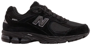 An all black 2002R new balance running shoes that is all black.