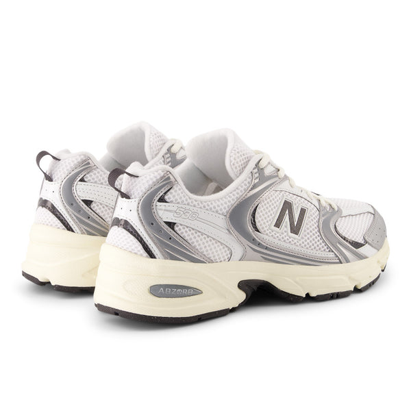 White and gray sneaker with New Balance logo on a white background