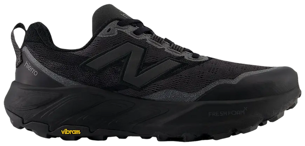 A black New Balance trail running shoe with a thick black midsole, black Vibram sole, and a gray 'N' logo on the side, shown against a plain white background.