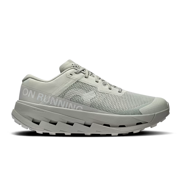 White and grey women's trail shoe with unique design on a black background