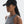 Woman wearing a black cap and gray tank top on a white background