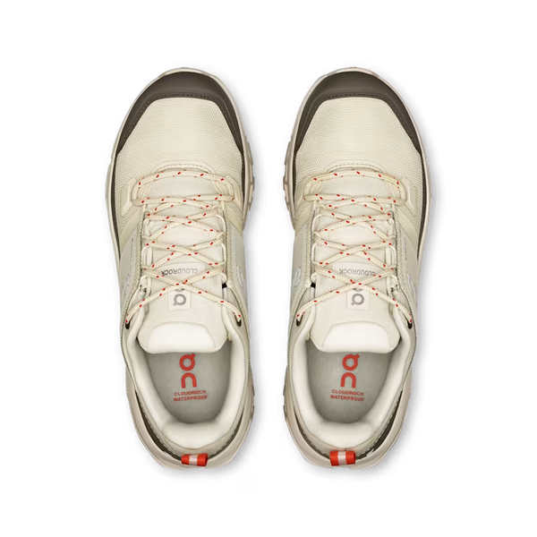 Pair of white sneakers with red accents on a transparent background