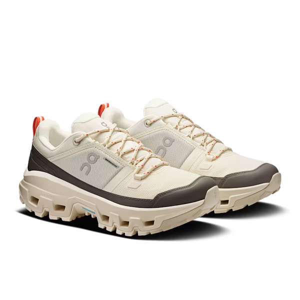 White and gray athletic shoes with a visible brand logo on a white background