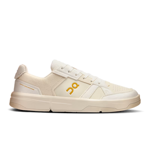 Beige sneaker with a yellow logo on a white background