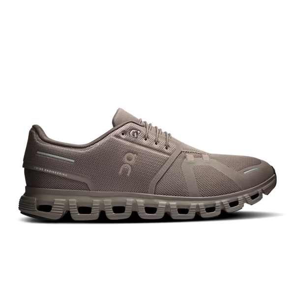 A single On running shoe in a taupe brown colorway, shown from the side against a solid white background. The shoe features a breathable mesh upper, a chunky sculpted sole with air pockets, and the On logo on the side.