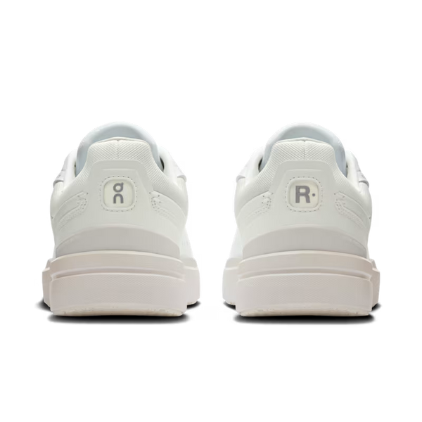 White sneakers with brand logos above the heels on a transparent background