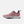 A pink New Balance athletic sneaker shown from the side profile against a solid white background. The shoe features a light pink mesh upper, a darker pink side panel with a large outlined 'N' logo, a white midsole, and black accents on the outsole and heel.