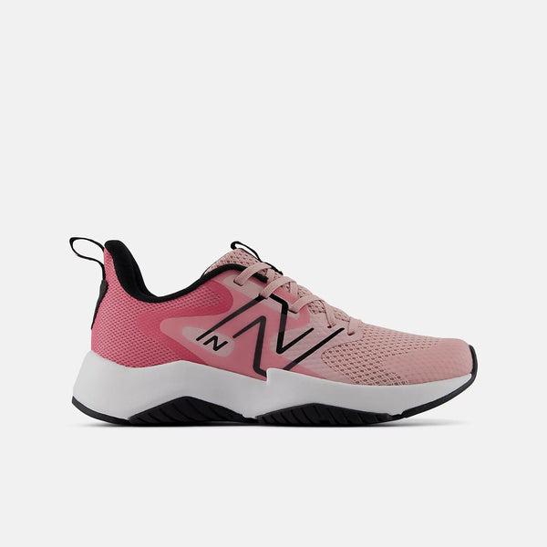 A pink New Balance athletic sneaker with a white and black midsole, featuring the signature black 'N' logo on the side, set against a plain white background.
