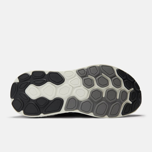 Close-up of a shoe sole with a white and black pattern on a light gray background