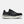Black running shoe with white sole on a light gray background