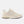 Beige sneaker with 'M' logo on a white background