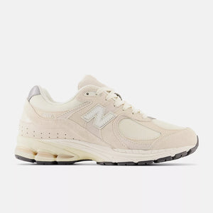 Beige sneaker with 'M' logo on a white background
