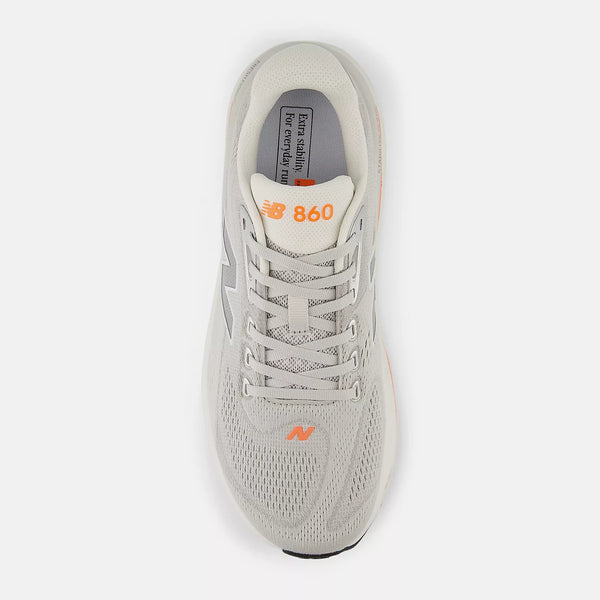 The top down view of this men's shoe has grey laces and orange pops.