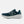 Blue'ish and green running shoe with white sole on a light gray background