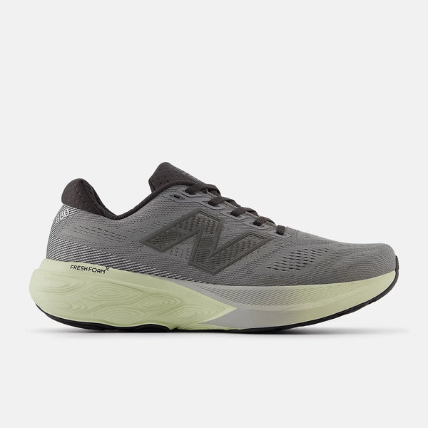 Gray running shoe with green sole on a white background
