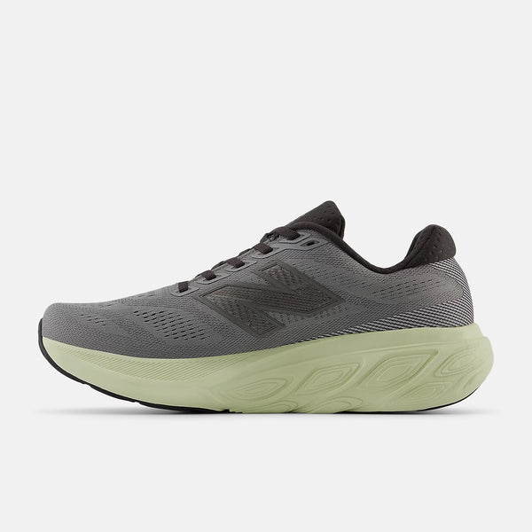 Gray running shoe with a green sole on a white background