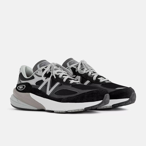 Black and gray sneakers with white soles on a light gray background